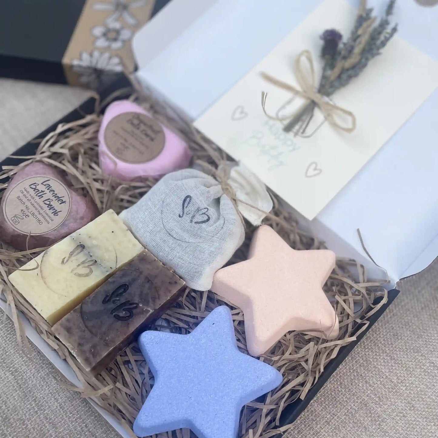 Close up on letterbox hamper with Happy Birthday card, bath bombs and soaps