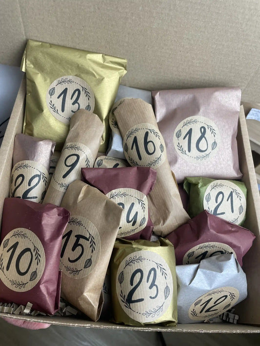 View of the 24-day beauty advent calendar,  mini handmade bath bombs and soaps wrapped in festive packaging
