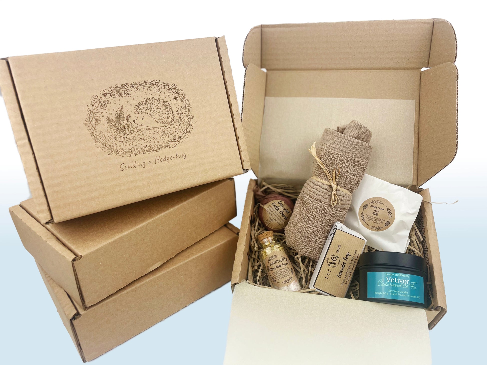 Laser etched gift box with cute hedgehog illustration sending a hedge-hug near the open box with self-care products