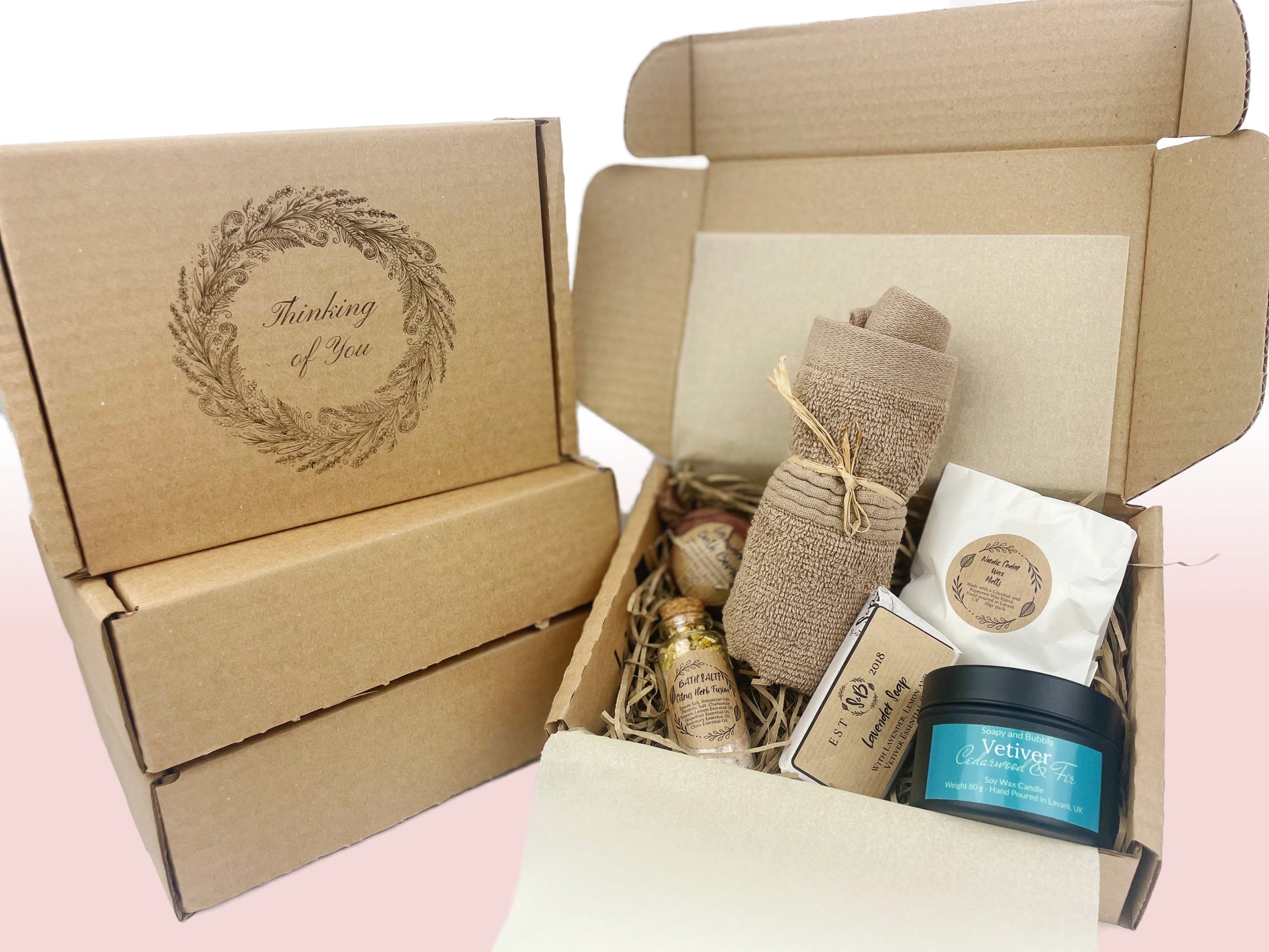 Thinking of you sympathy gift box with floral wreath etching, near the open box with self-care products