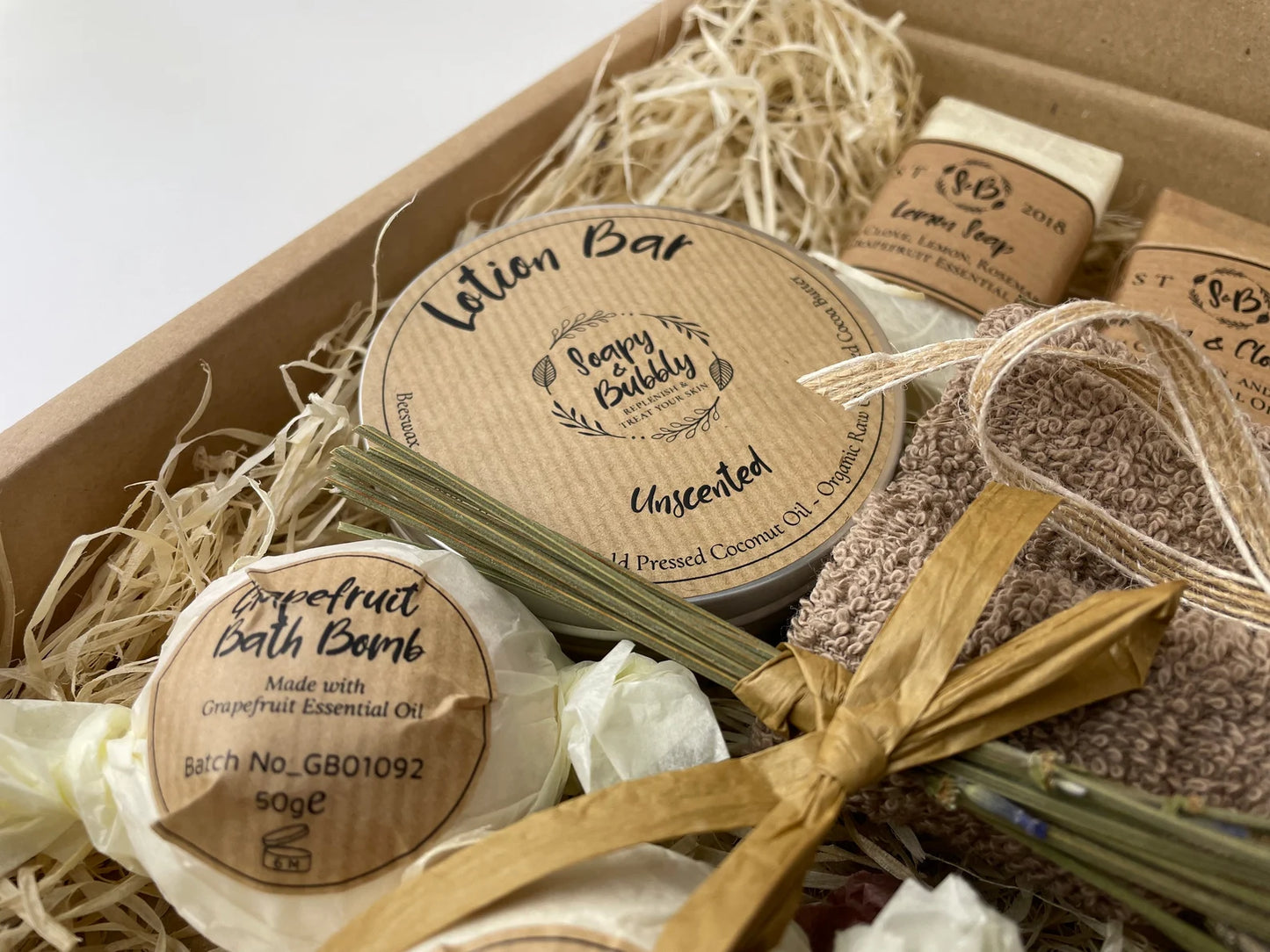 Close-up of artisan handmade soap and a fizzy bath bomb from a self-care relaxation kit.