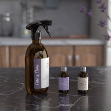 Load image into Gallery viewer, Surface cleaner made with plant based ingredients and refill bottles on the kitchen table. Lavender plant in the foreground.
